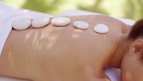 woman having a hot stone spa massage