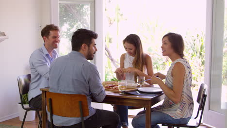 grupo de amigos disfrutando de una cena en casa juntos