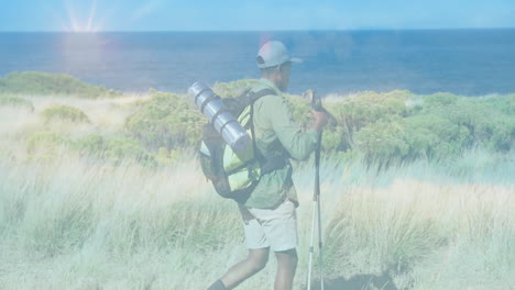 man adjusting hiking poles on coastal dune trail, showing animated route map and health chart