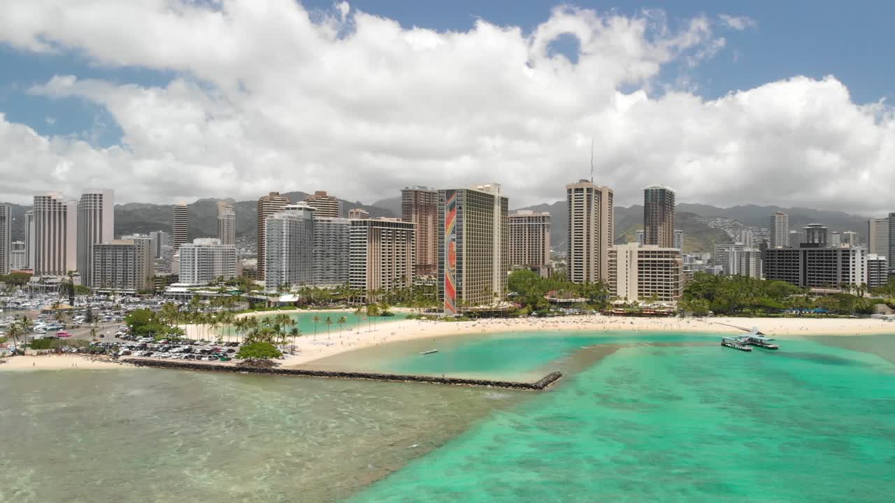 Version One. Beautiful Aerial Orbit over Waikiki Beach, Honolulu, and Kahanamoku Beach with crystal clear ocean