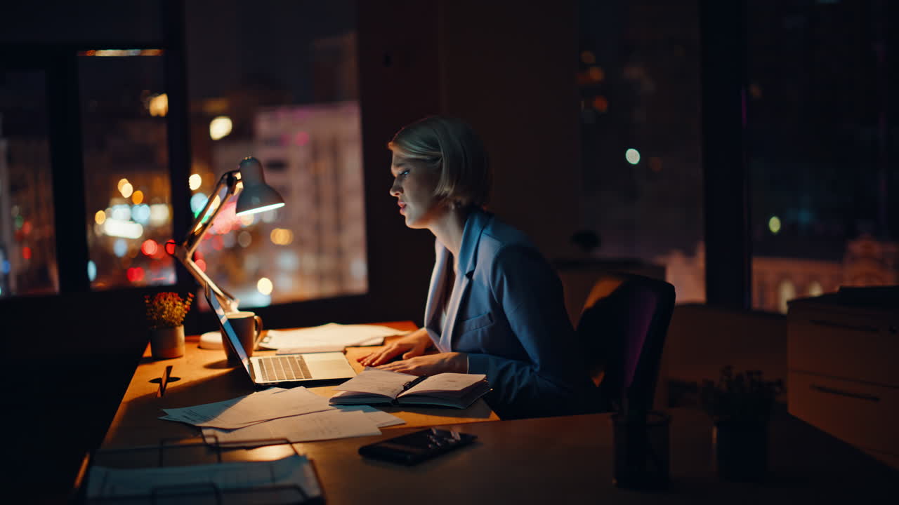 Late worker writing notes at night office lamp light. Upset manager closing lid