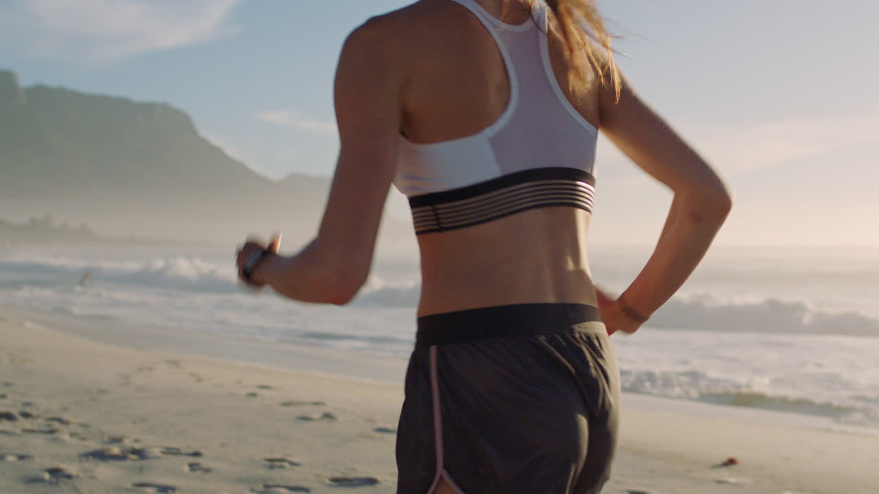 Fit, active athlete running on beach