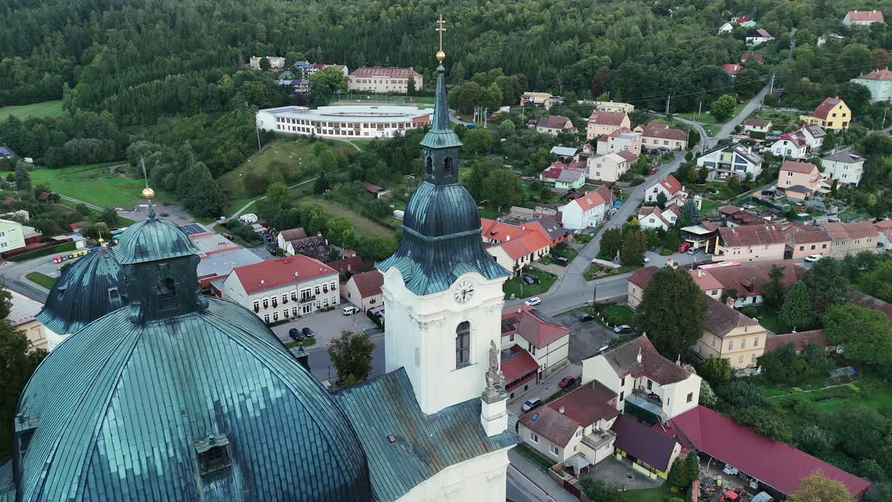Aerial shot around Křtiny church rooftop and clock tower