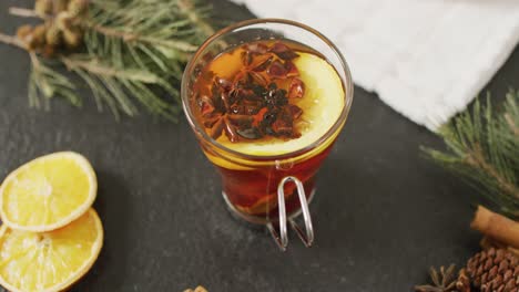 video of cup of hot tea with cinnamon and lemon over grey background