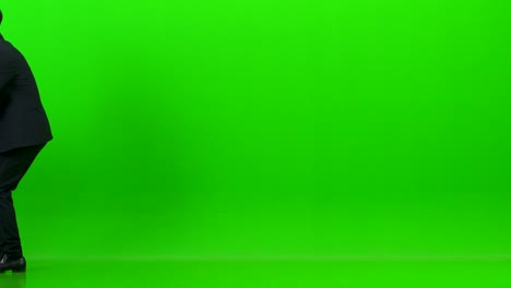 the happy man and a woman playing on the office chair on the green background