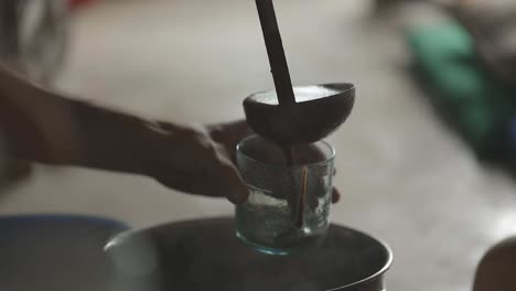 pouring liquid ceremonial cacao into a cup