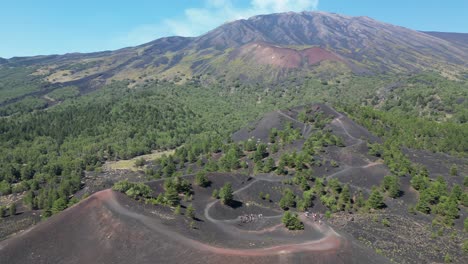 group tourist people hike on mount etna volcano craters in sicily, italy - aerial 4k