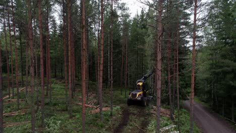 aerial following shot of scandinavian finnish forest and forestry machine ponsse scorpion harvester, shot with dji air 2s