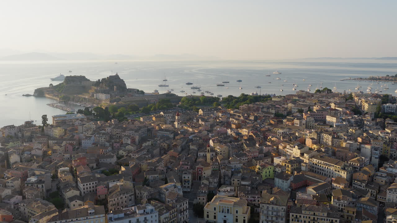 Old town of Corfu and yacht harbour with old fortress in view at sunrise, Drone shot, Panoramic view