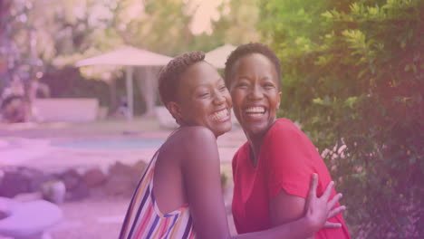 two african american sisters hugging each other at a resort