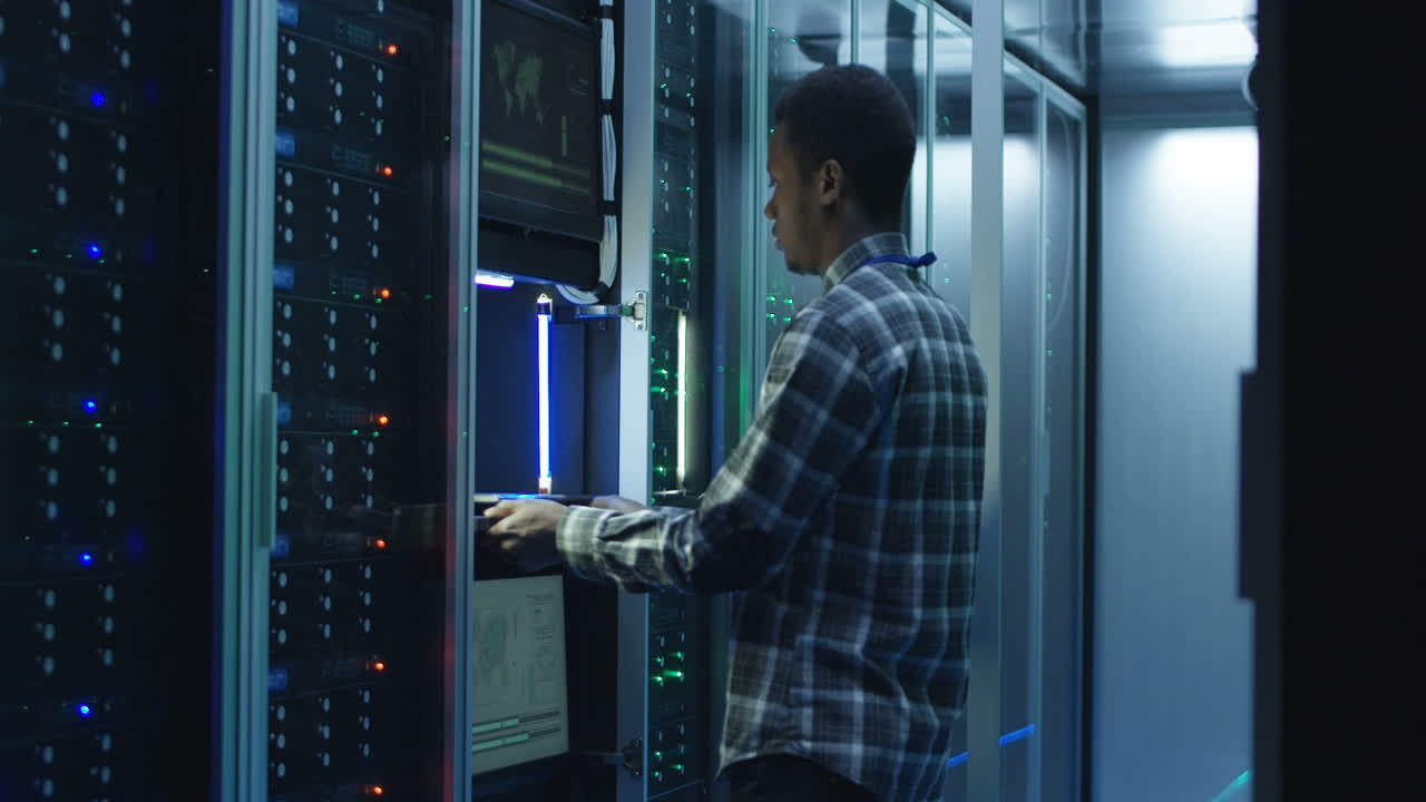 African American IT technician working in a server room