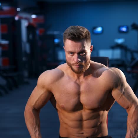 athletic body. shirtless model guy is posing to the camera. strong muscular man with perfect body