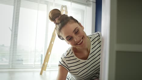 video of happy woman pointing old furnitures with a roller.