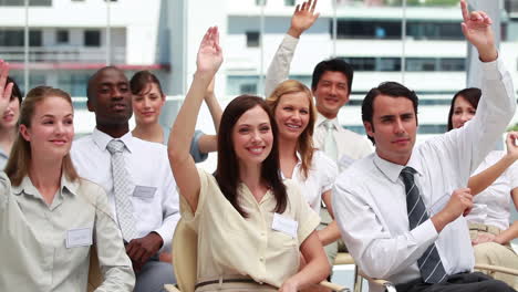 two business people raising their hands