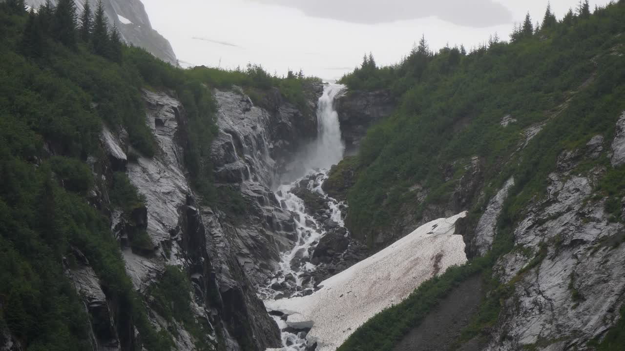 Waterfall as viewed from the Endicott Arm fjord, Alaska, in a misty morning.
