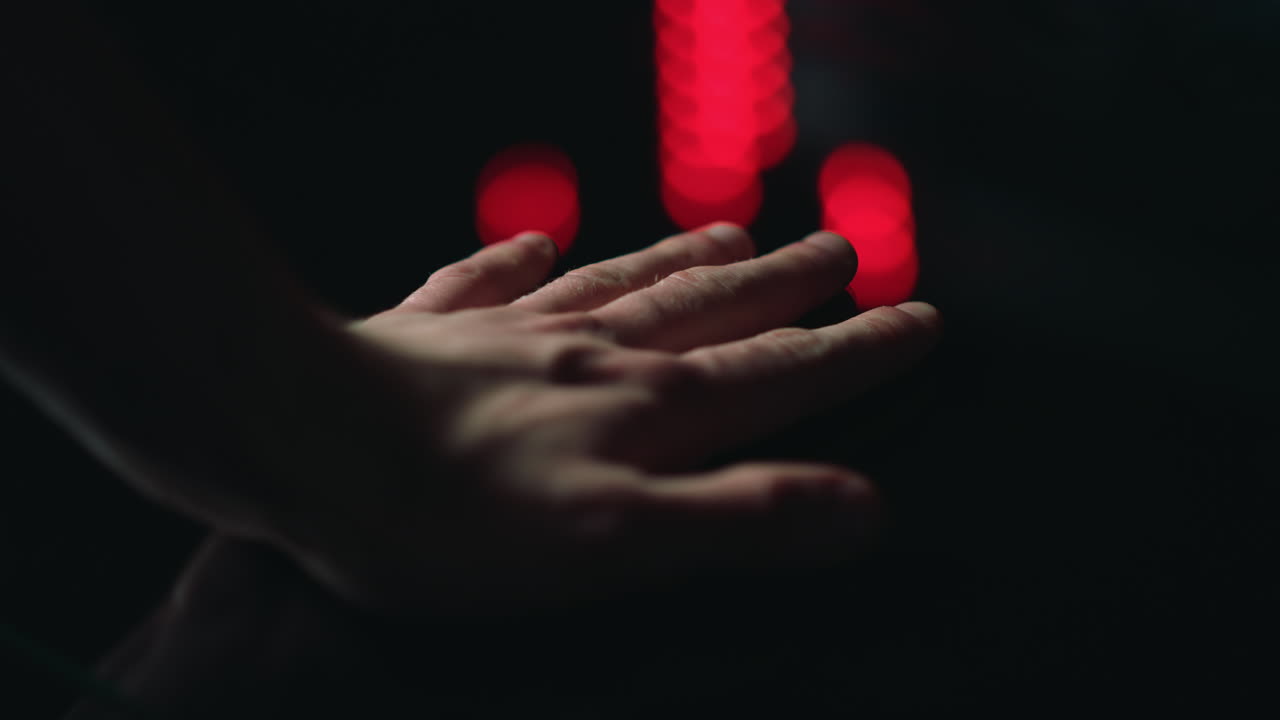Macro of man hand putting on black surface indoors. Male palm touching.