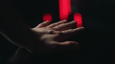 macro of man hand putting on black surface indoors. male palm touching.