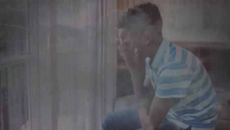 animation of rain over sad african american boy