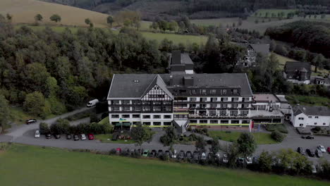 aerial view of the alpin hotel in the spa and ski village of grafschaft in the sauerland region near winterberg against a blue sky with clouds