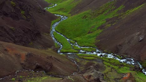 Flyby-Stream-Flowing-Between-Slopes-At-Reykjadalur-Valley-In-Iceland