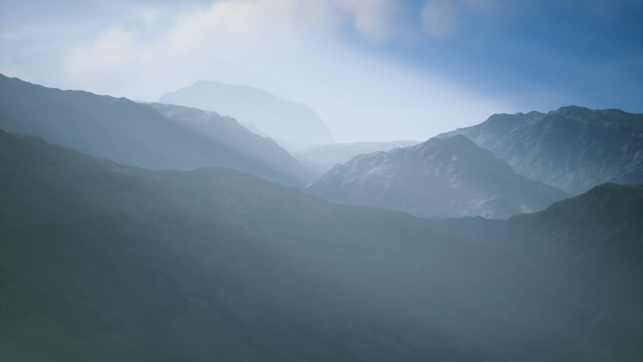 Misty mountains create a tranquil atmosphere during early morning hours