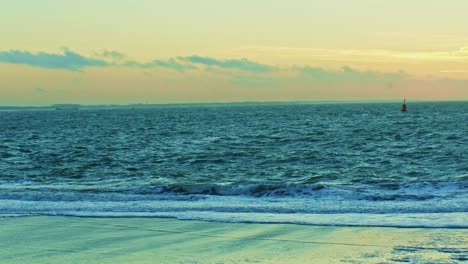 ocean-and-seashore-beach-view-in-the-evening-sunset-time-afterglow-with-waves,-water-and-sun