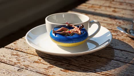 miniature man sunbathing in a coffee cup