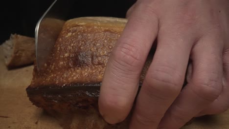 Slow-motion-close-up-shot-of-chef-cutting-freshly-baked