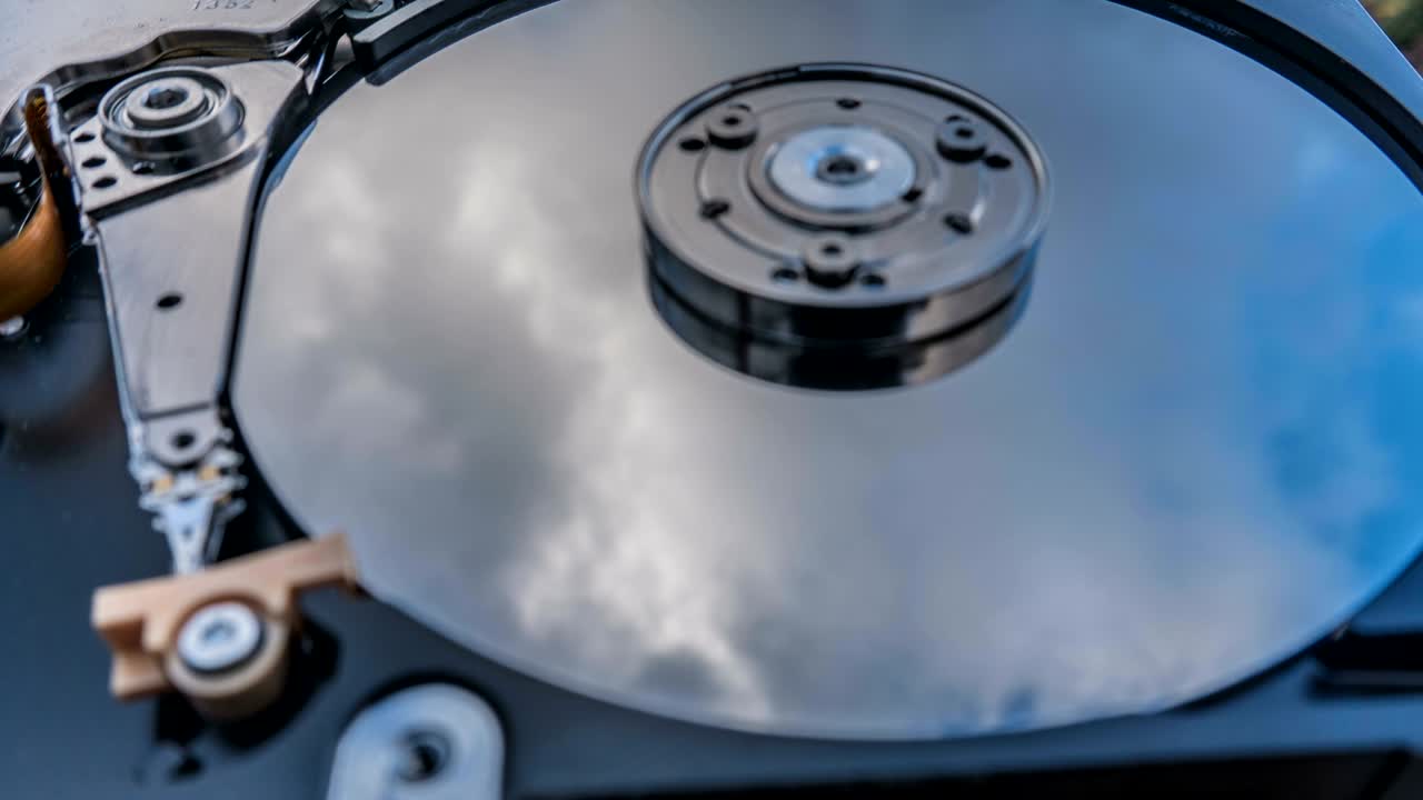 Hard disk drive with reflected in it the time-lapse of clouds, the concept of cloud storage