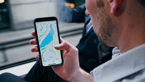 man using navigation app on smartphone