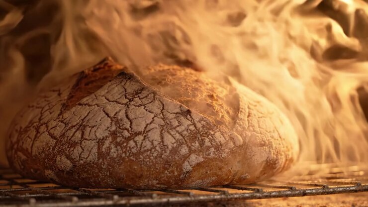 Artisan Bread Baking: A Crusty Loaf Emanating Warmth and Aroma, Captured in Glorious Detail as it Rises and Steams in the Oven's Embrace
