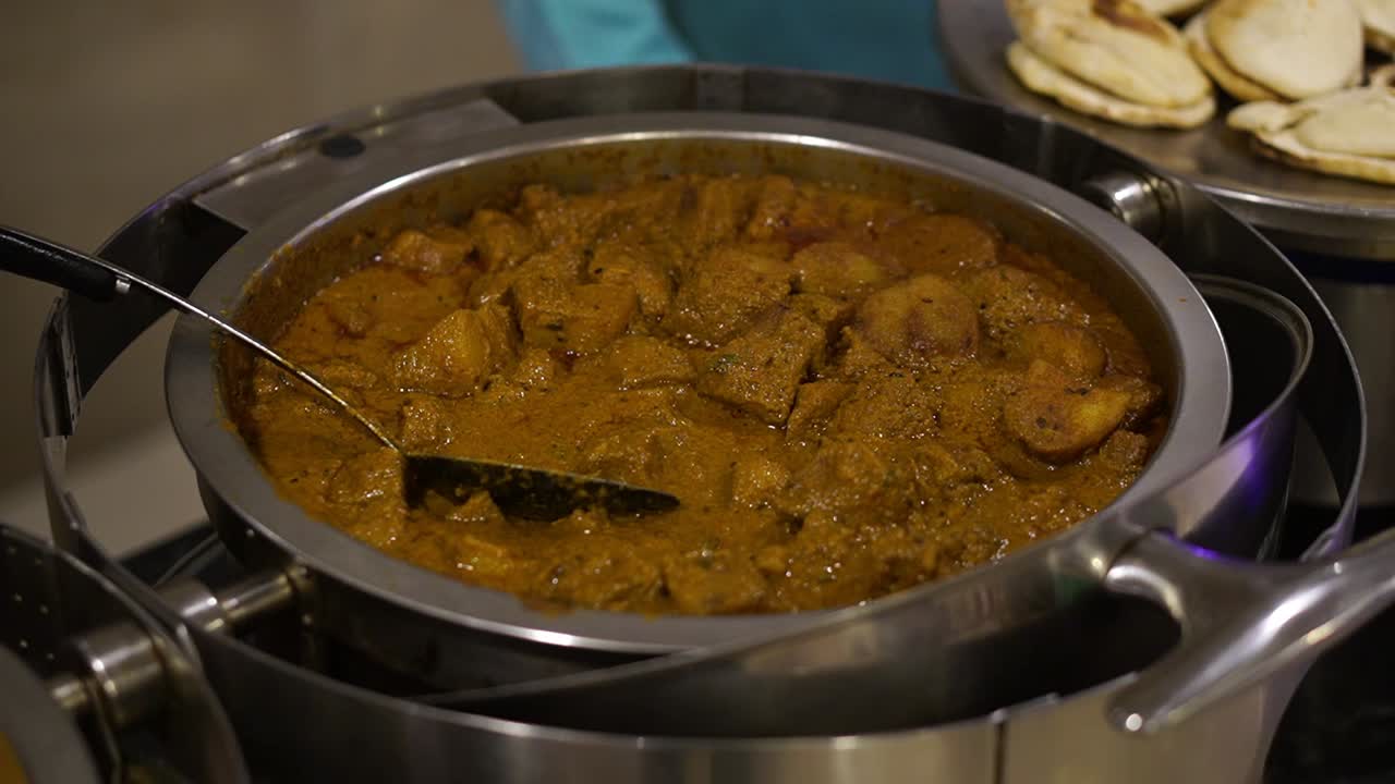 Featuring of Bengali style aloo dum with spatula on tray in wedding.