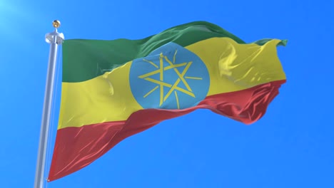 Flag of Ethiopia waving at wind with blue sky in slow, loop