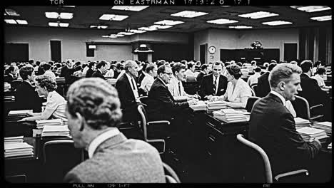 black and white montage of politicians and journalists working at desks in a bustling newsroom, reviewing documents and engaging in discussions