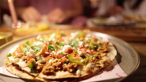 A vibrant scene of a Mexican-style pizza being prepared and served in a warm, inviting setting with soft lighting