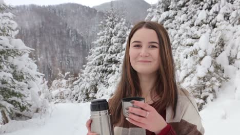 young pretty girl drinks hot tea on the date in winter forest young pretty girl drinks hot tea on the date in winter forest