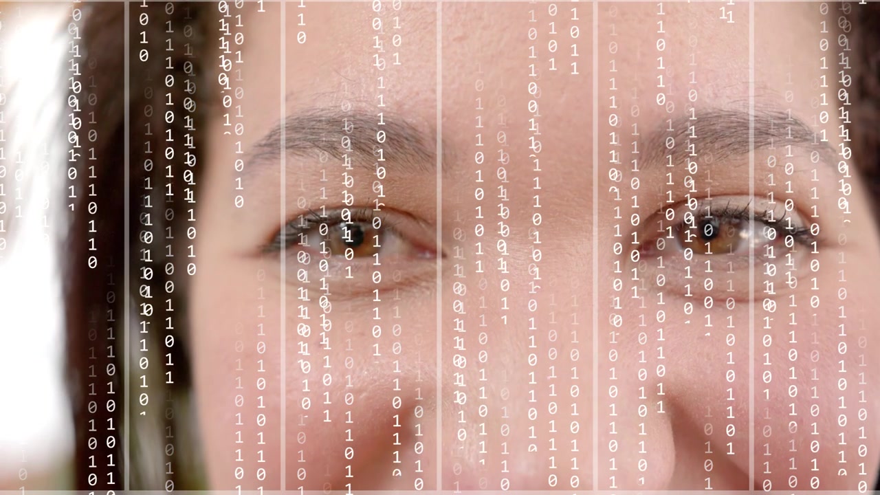 Woman smiling and narrowing eyes while overlay starting falling binary grid over face for tech demo