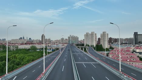 drone aerial view of traffic and highway in the city during sunset