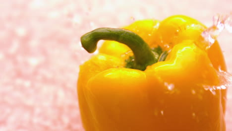 water pouring on yellow pepper