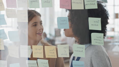 creative business women using sticky notes brainstorming colleagues working together problem solving discussing solution enjoying teamwork in startup office