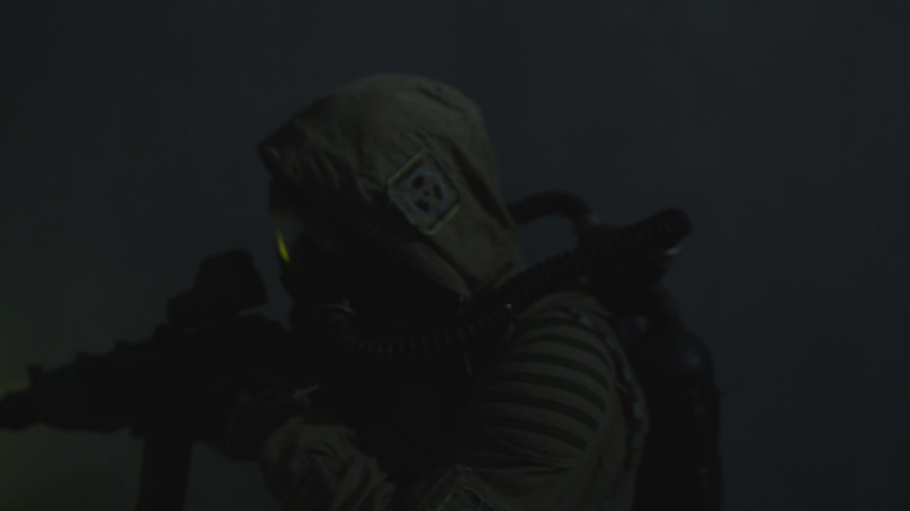 A wounded soldier in the abandoned military complex approaches anomaly