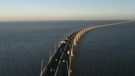 aerial drone video of ponte vasco da gama bridge with cars passing by