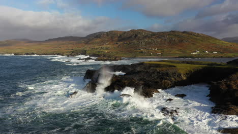 Cinematic-drone-shot-of-the-ocean-waves-crashing-against-the-White-Cliffs-of-Ashleam,-Ireland