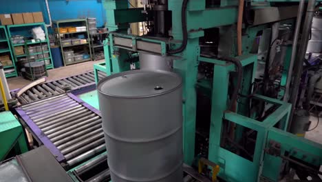 implement an automated system for securing steel barrel lids