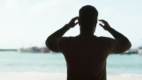 fitness, thinking and man stretching by ocean