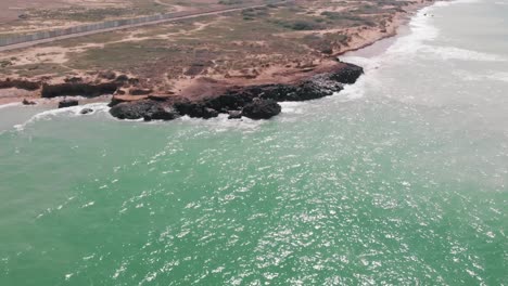 aerial over turquoise ocean revealing balochistan coastline