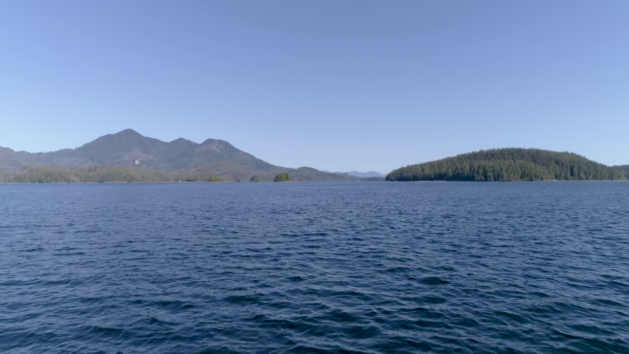 Flying above the water by the coast of Vancouver Island (British Columbia - Canada). Drone footage.
