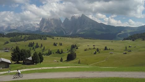 one guy cycles through the mountains ranges of the seiser alm italian alps, urtisei, urtijei, alpe di siusi,italy, europe