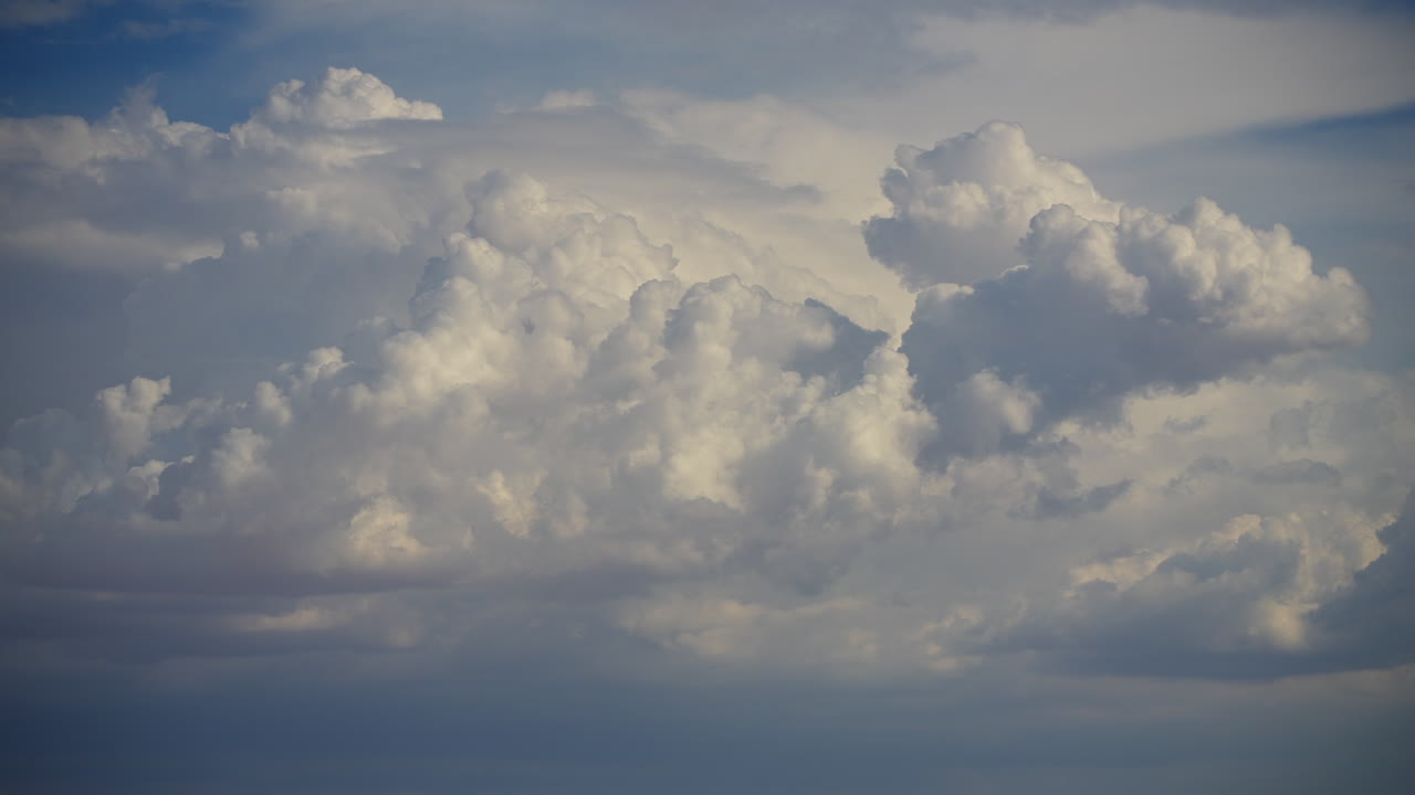 Huge cumulonimbus clouds billowing and drifting in the atmosphere - time lapse