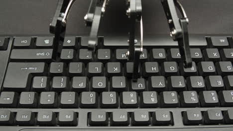 robot hand typing on a keyboard